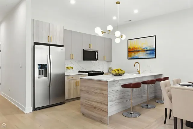 a kitchen with a refrigerator a sink and a stove