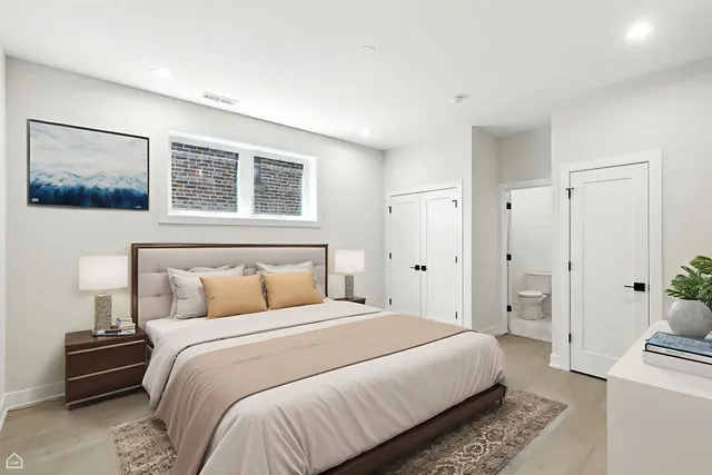 a bedroom with a bed and a painting on the wall