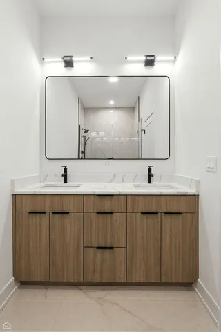 a bathroom with a double vanity sink and mirror