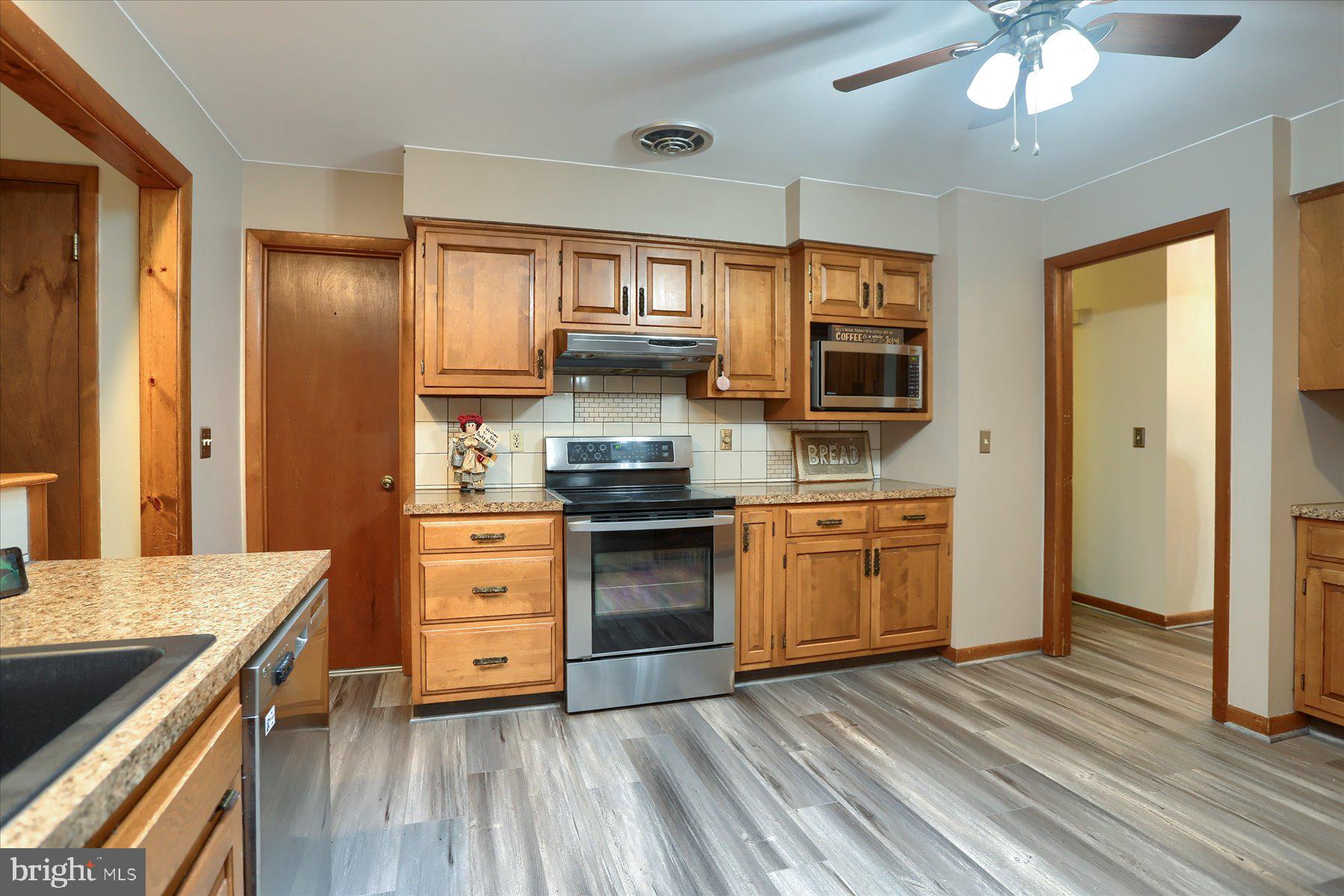 12 South Ridge Road Boiling Springs, PA 17007 - Photo 10 of 39 a kitchen with stainless steel appliances granite countertop a stove and cabinets