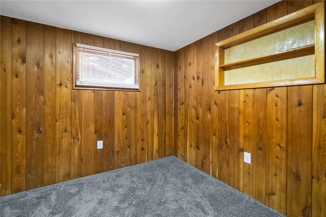 121 Short Ridge Road Albrightsville, PA 18210 - Photo 19 of 35 Rich wood paneling walls and plush carpeting create a cozy, cabin-like interior atmosphere.