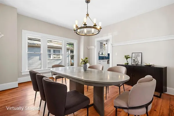 a view of a dining room with furniture window and wooden floor