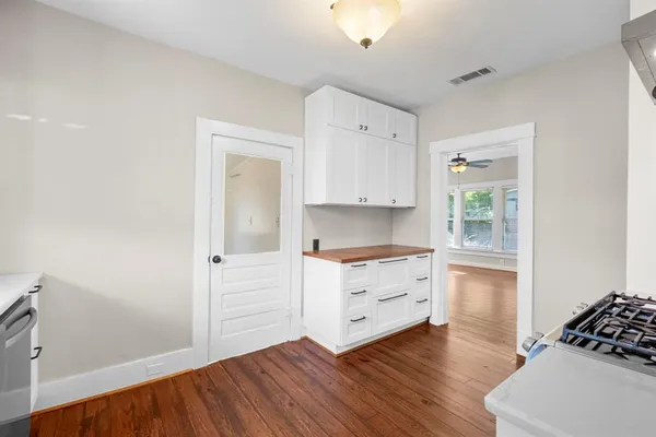 a room with hard wood floors and a window