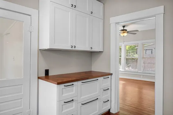 a kitchen with granite countertop white cabinets and a stove