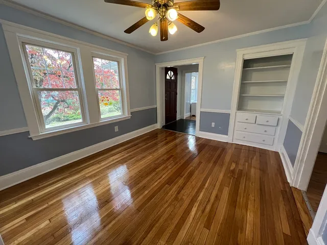wooden floor in an empty room with a window