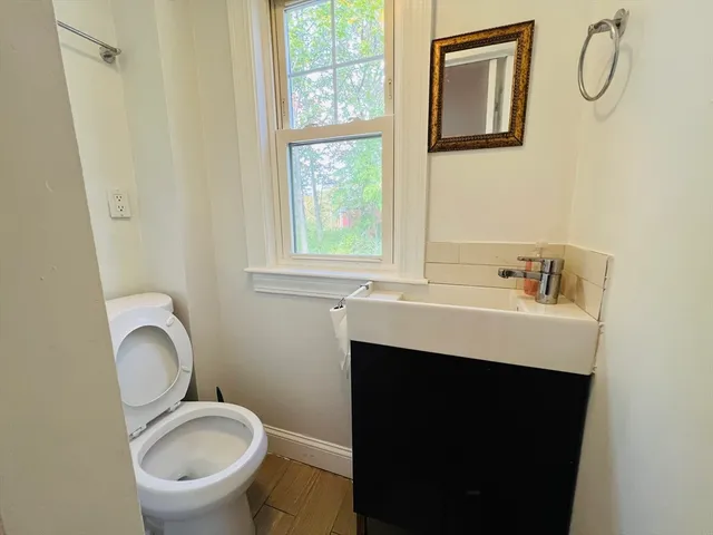 a bathroom with a sink toilet and a mirror