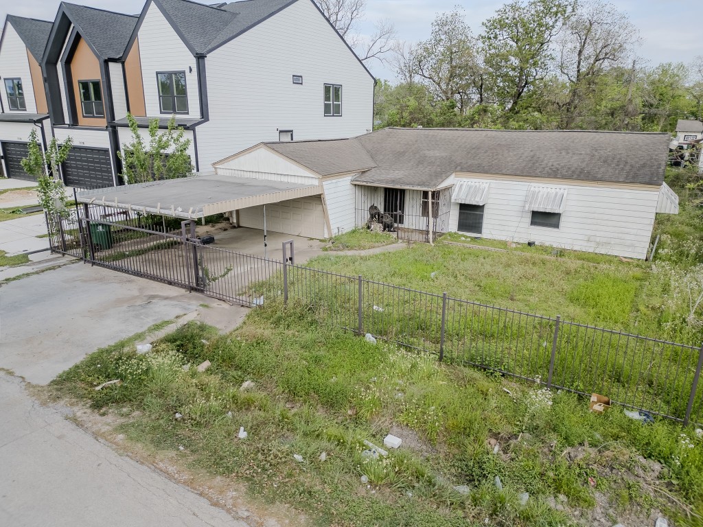 a aerial view of a house with table and chairs under an umbrella