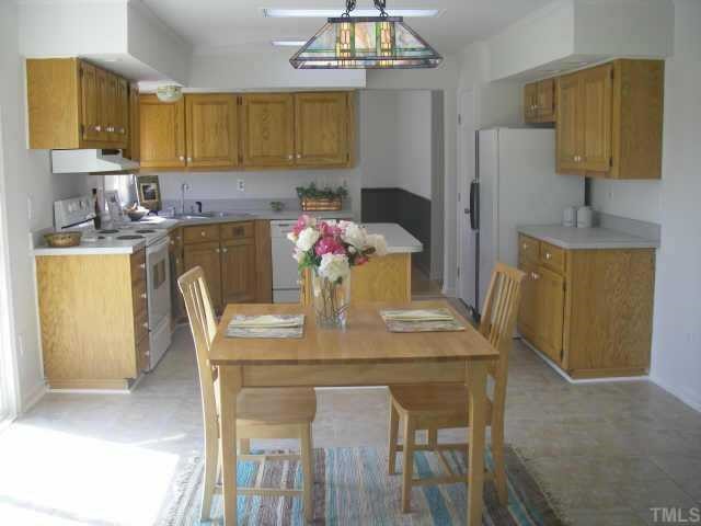 8811 Art Road Cedar Grove, NC 27231 - Photo 3 of 11 Kitchen includes refrigerator, dishwasher, disposal, and new stove. Opens to dining room, family room, and back deck.