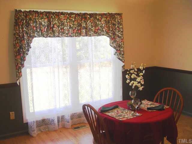 8811 Art Road Cedar Grove, NC 27231 - Photo 4 of 11 Formal dining room has chair rail & laminate flooring.