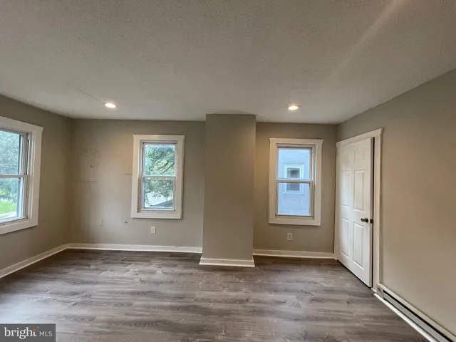 an empty room with windows and closet
