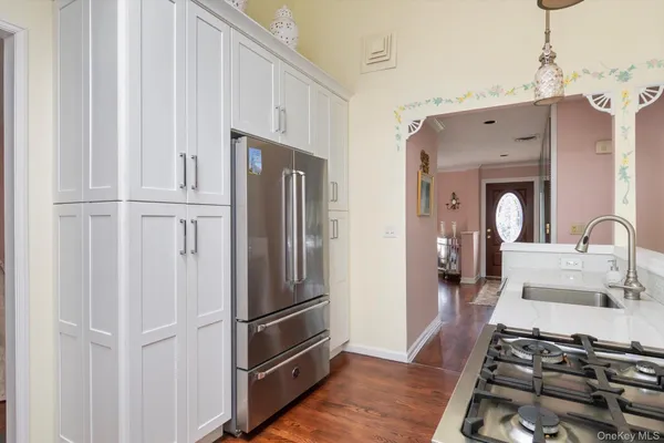 a kitchen with stainless steel appliances a refrigerator sink and cabinets
