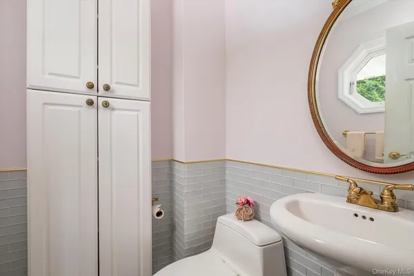 a bathroom with a sink a toilet and a mirror