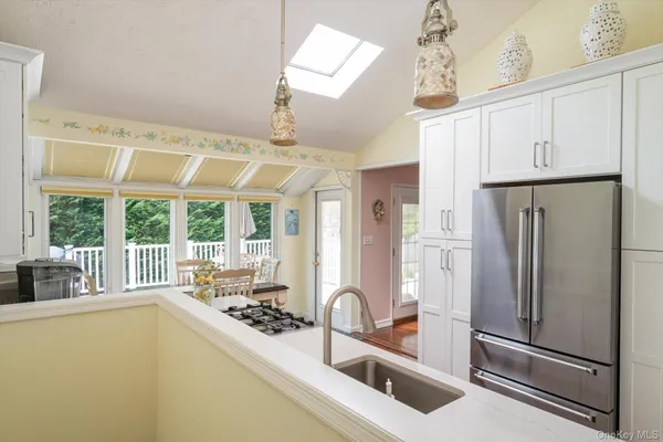 a kitchen with stainless steel appliances granite countertop a refrigerator and a sink