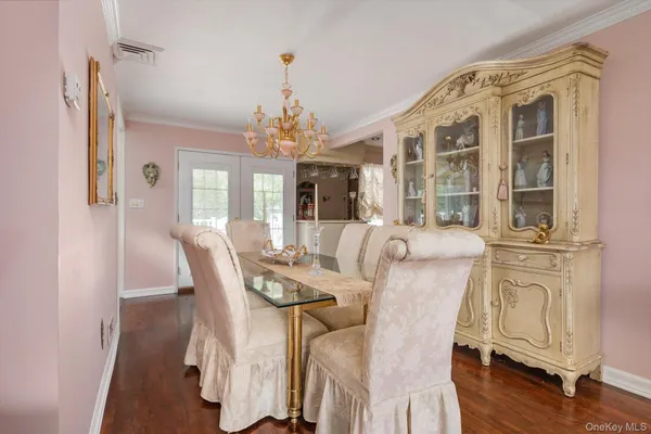 a view of a dining room with furniture wooden floor and chandelier