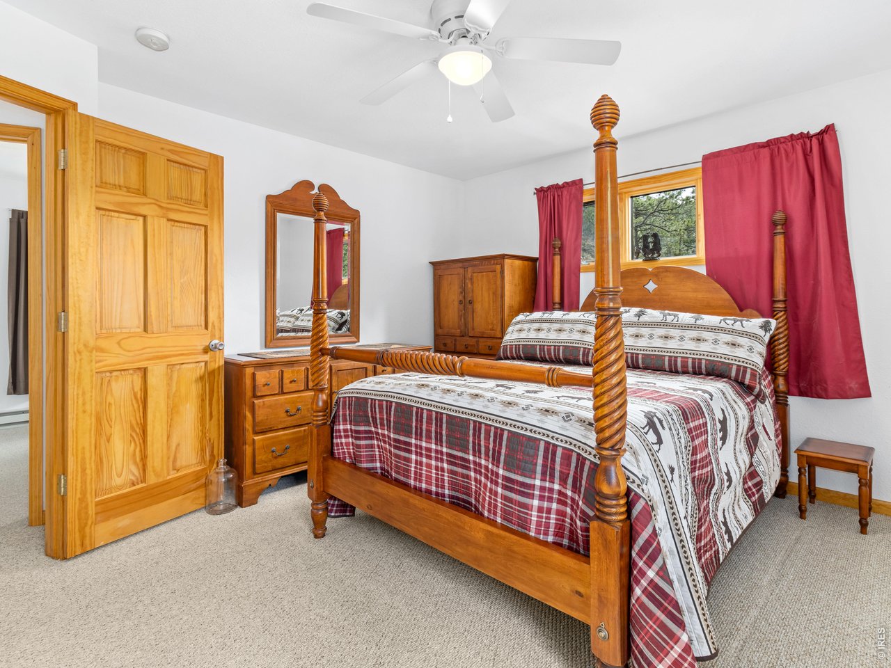 1002 Streamside Drive Drake, CO 80515 - Photo 14 of 37 a bedroom with a bed and a chandelier