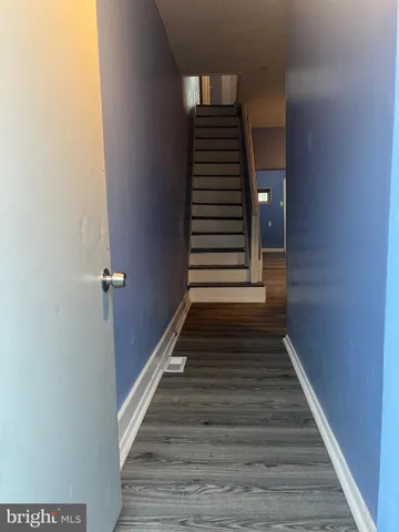 a view of entryway and hall with wooden floor