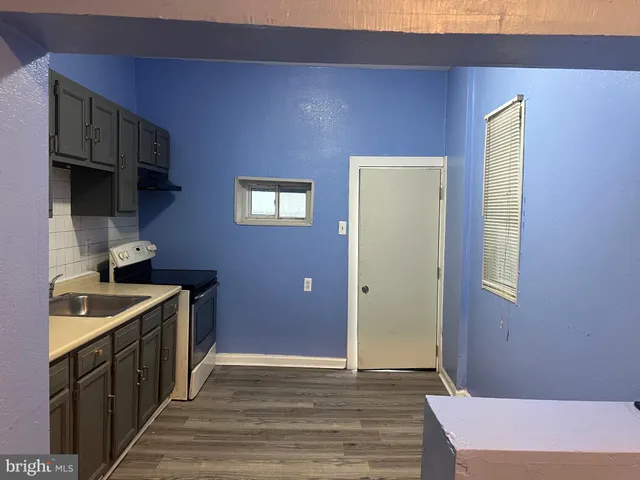 a kitchen with a sink stove and cabinets