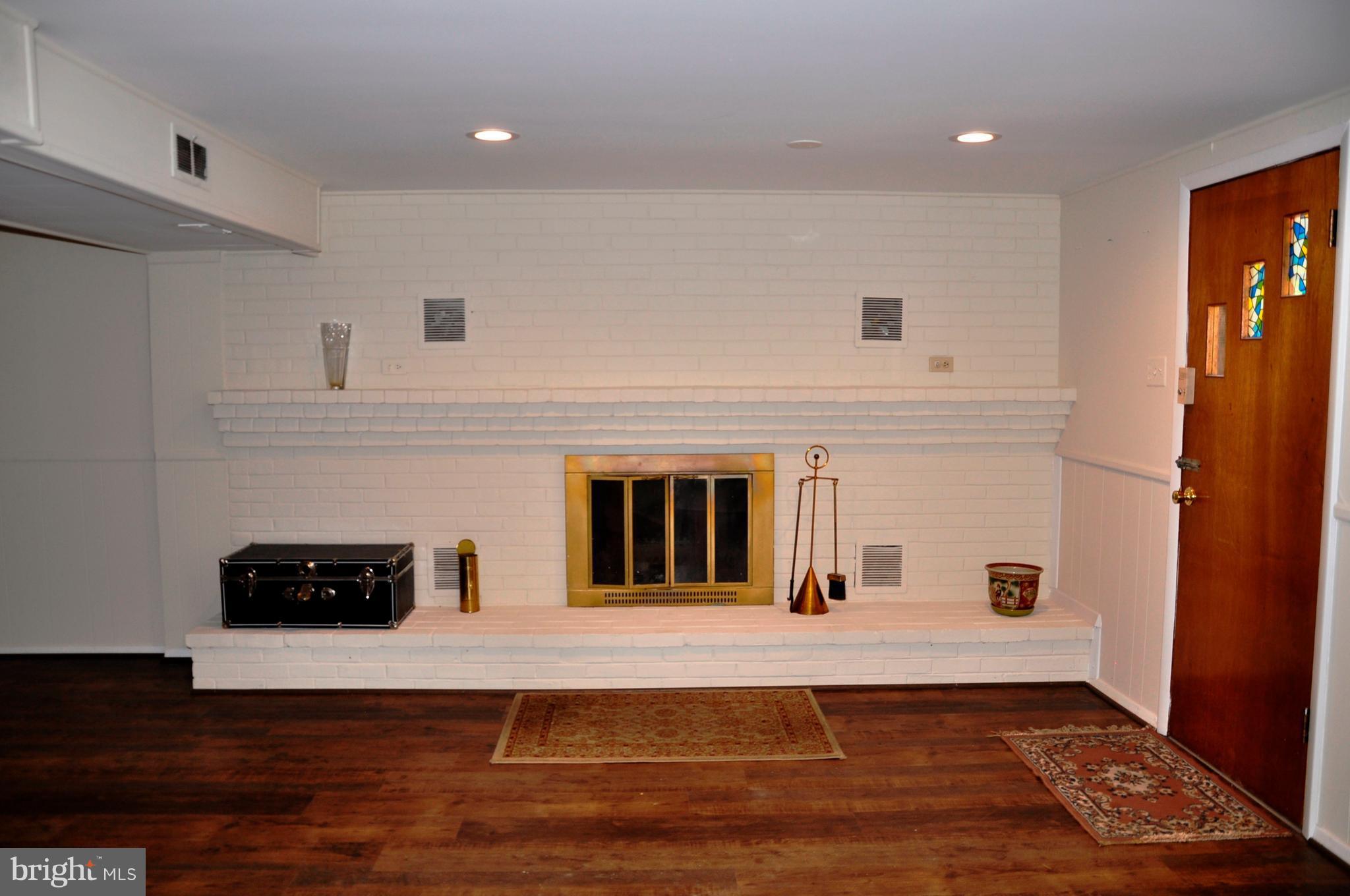 11405 Veirs Mill Road Wheaton, MD 20902 - Photo 13 of 24 Family room w/ fireplace, private rear entry
