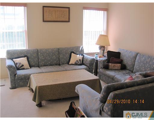 25 Woodbury Road Edison, NJ 08820 - Photo 2 of 8 a bedroom with furniture and a window
