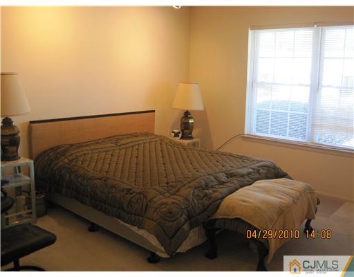 25 Woodbury Road Edison, NJ 08820 - Photo 5 of 8 a bedroom with a bed and a window