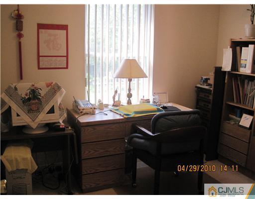 25 Woodbury Road Edison, NJ 08820 - Photo 7 of 8 a bedroom with a bed and a closet