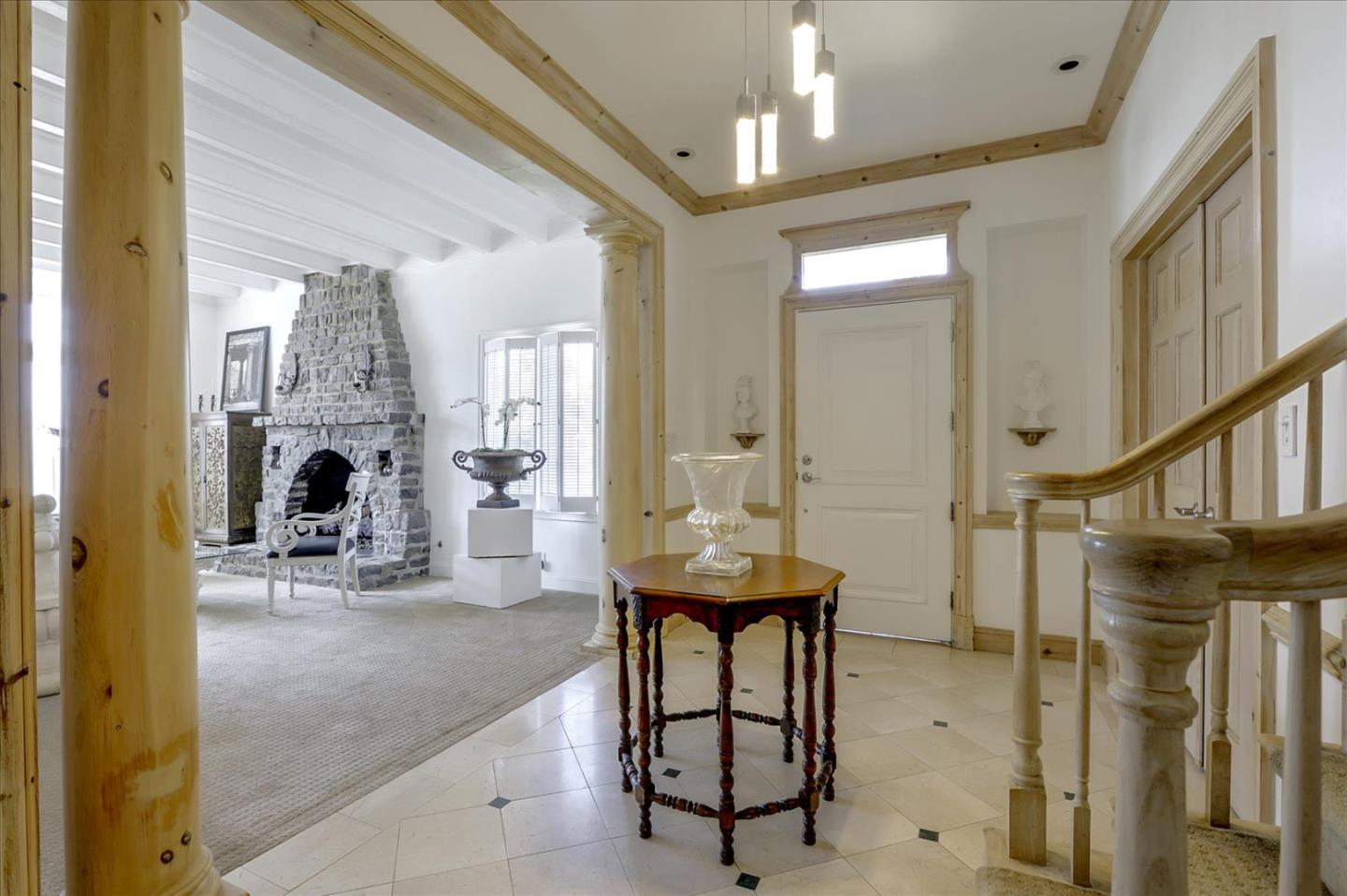 85 Clarendon Road Pacifica, CA 94044 - Photo 12 of 74 a living room with furniture a fireplace and a chandelier