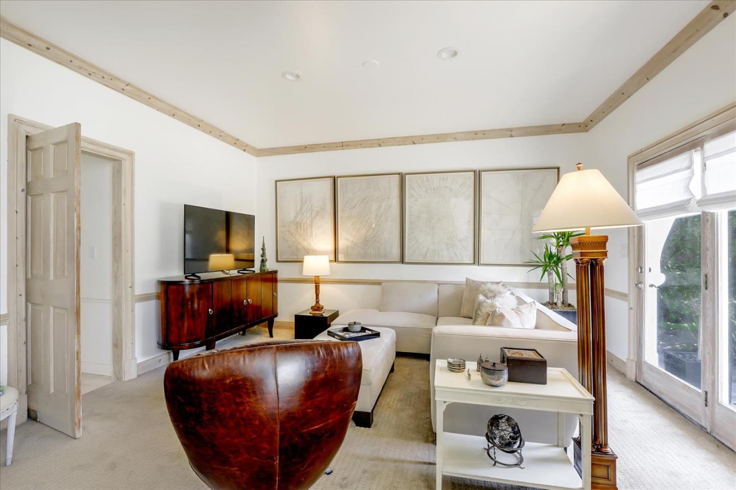 85 Clarendon Road Pacifica, CA 94044 - Photo 22 of 74 a living room with furniture a flat screen tv and a floor to ceiling window
