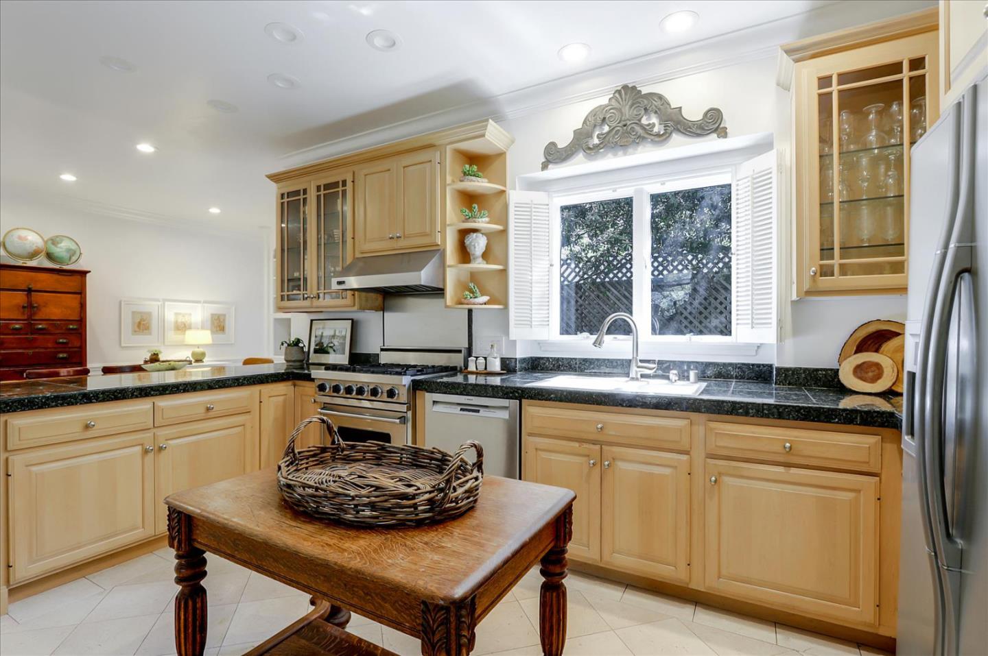 85 Clarendon Road Pacifica, CA 94044 - Photo 25 of 74 a kitchen with stainless steel appliances granite countertop a stove a sink dishwasher a microwave oven and a dining table with wooden cabinet