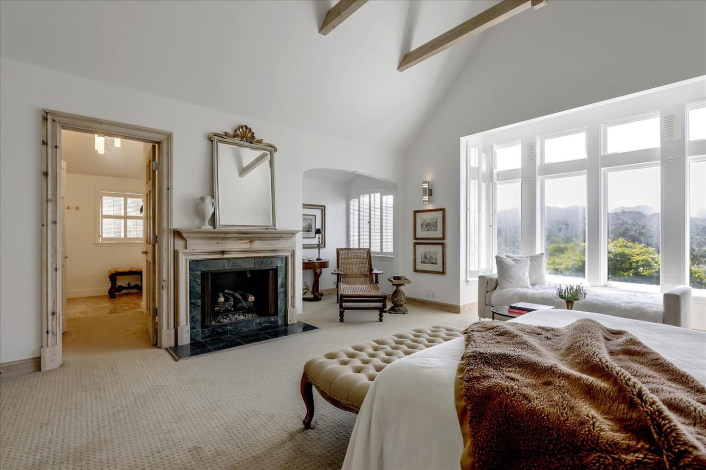 85 Clarendon Road Pacifica, CA 94044 - Photo 54 of 74 a spacious bedroom with a bed and a fireplace