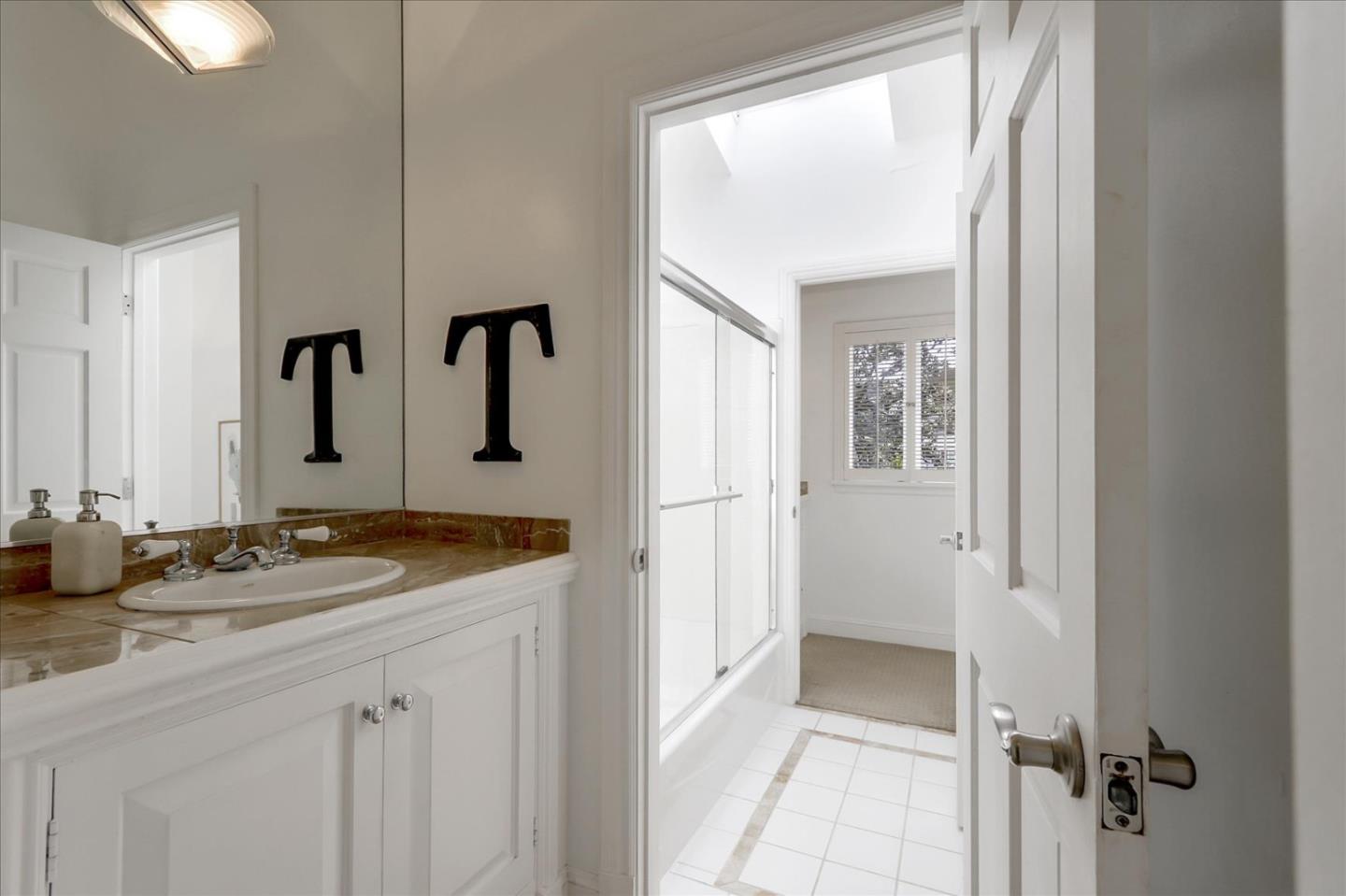 85 Clarendon Road Pacifica, CA 94044 - Photo 59 of 74 a bathroom with a granite countertop sink and a mirror