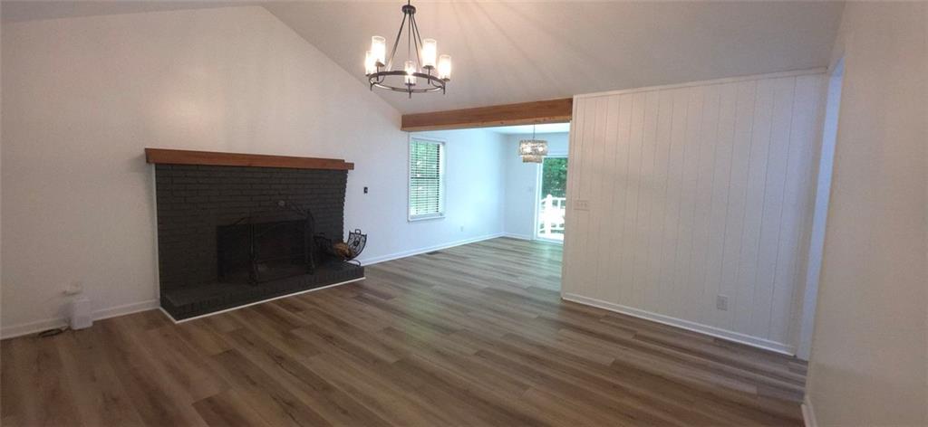 1774 Joe Black Road Sautee Nacoochee, GA 30571 - Photo 4 of 20 a view of empty room with wooden floor and fireplace