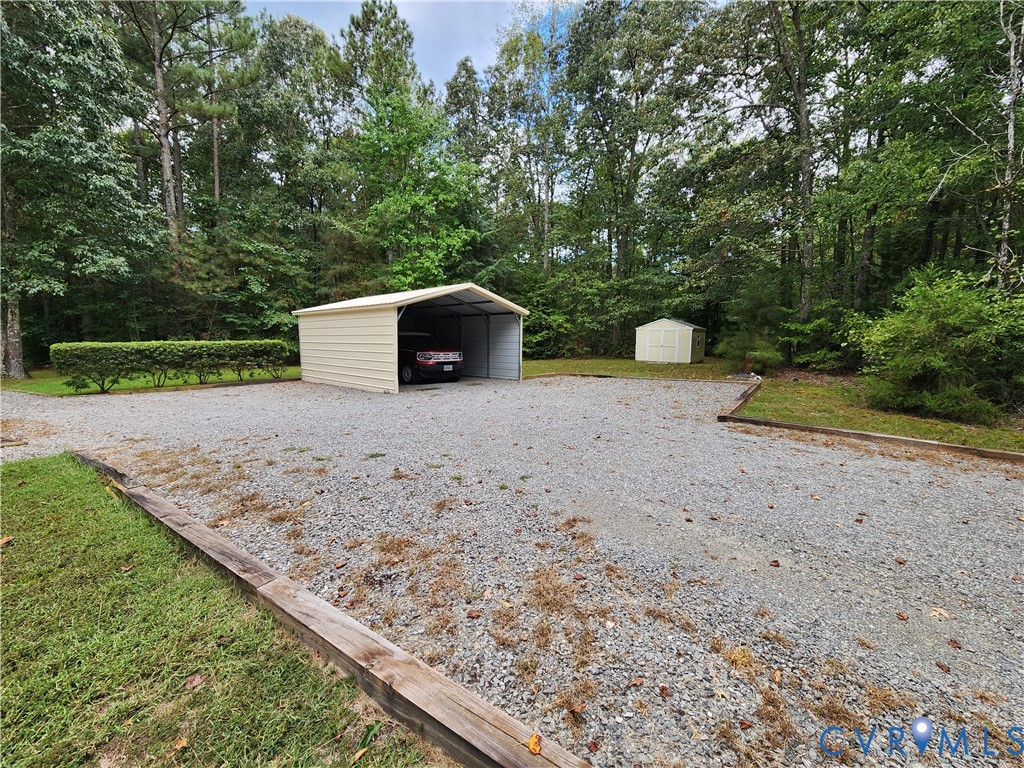 2744 Smokey Road Aylett, VA 23009 - Photo 62 of 72 Gravel driveway with a metal carport and an additi