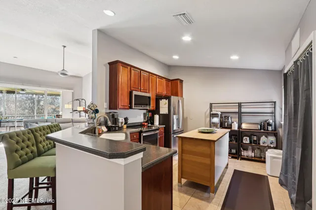 a kitchen with a stove a refrigerator sink dishwasher and fireplace with wooden floor