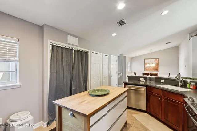 a kitchen with a sink a stove a refrigerator and cabinets