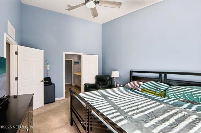 a bedroom with a bed and a chandelier