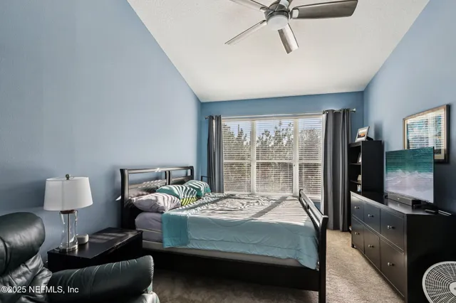 a bedroom with furniture and a flat screen tv