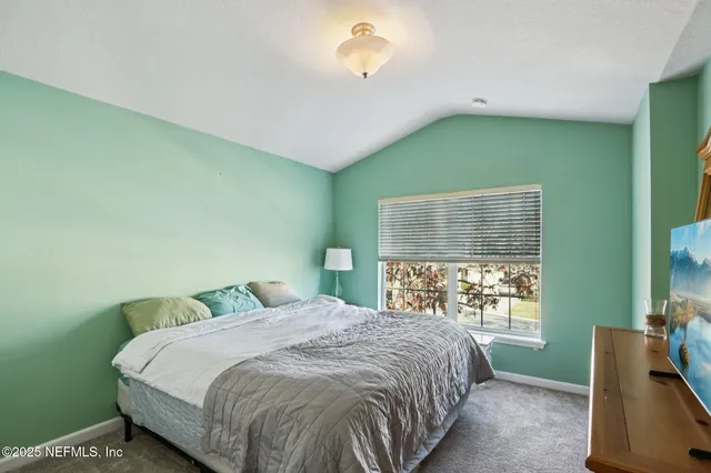 a bedroom with a bed and window