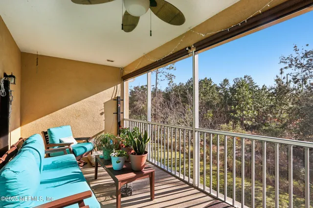 a balcony with wooden floor and outdoor seating