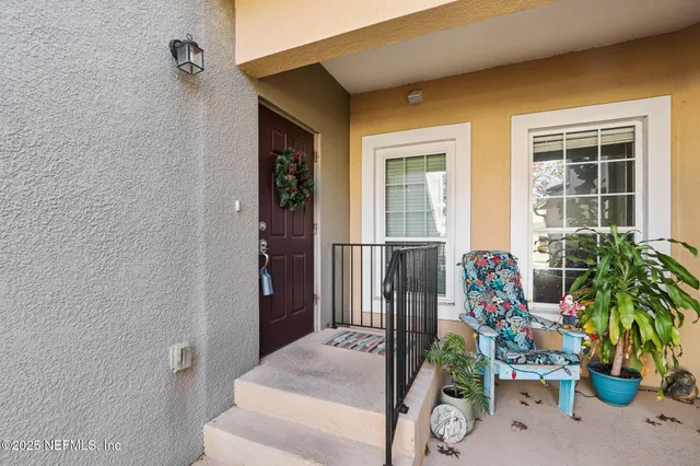 a house with potted plants in front of door