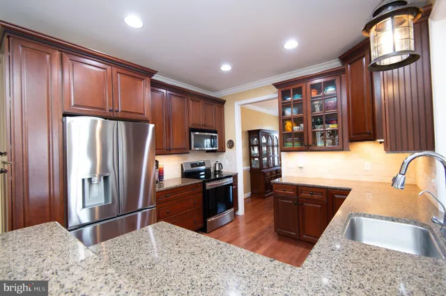 a kitchen with center island table and chairs