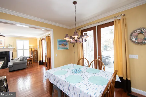 a kitchen with stainless steel appliances granite countertop a stove refrigerator and a view of living room