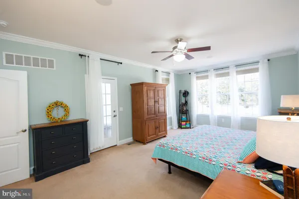 a bedroom with a bed and a lamp with window