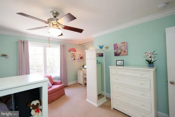 a spacious bedroom with a bed and a chandelier