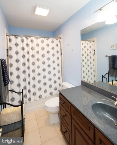 a spacious bedroom with a bed and a chandelier