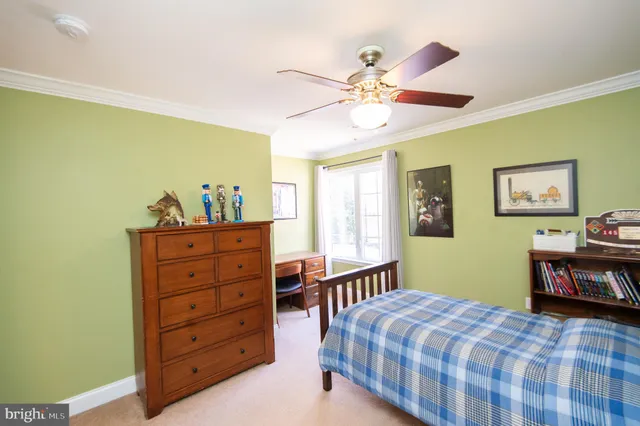 a bedroom with a bed and paintings on the wall