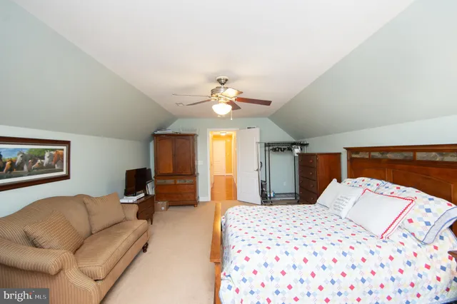 a bedroom with furniture and a flat screen tv