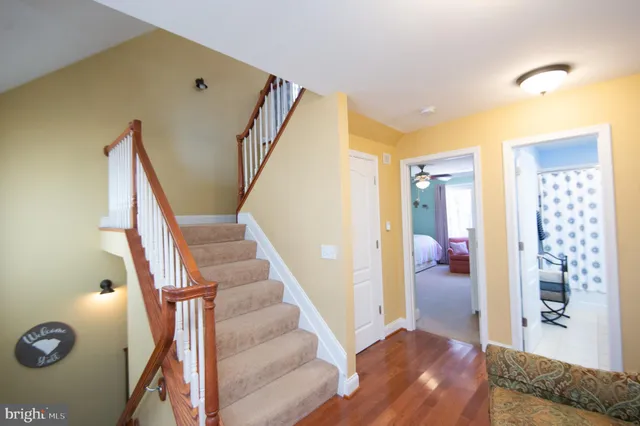 a bedroom with a large bed couch and window