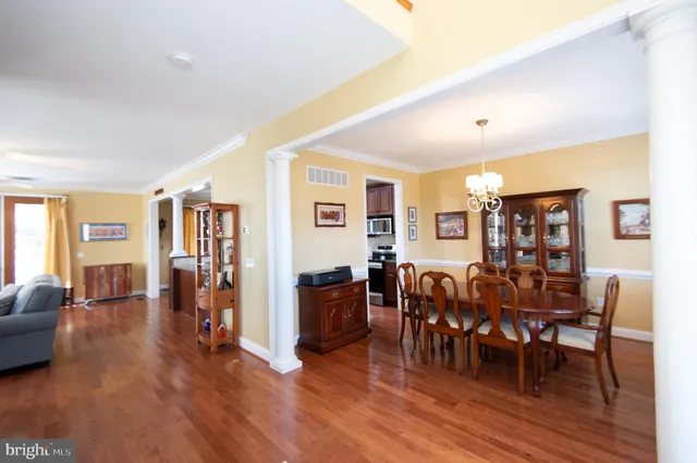 a view of a dining room with furniture and wooden floor