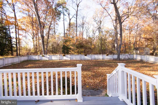 a view of a yard in front of a house with large tree