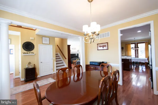 a dining room with furniture and wooden floor